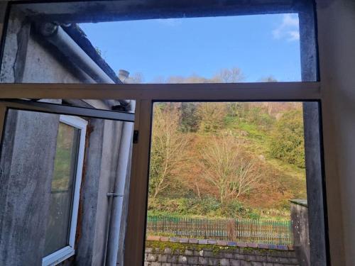 a window with a view of a hill outside at Ideal for short stays in Cork