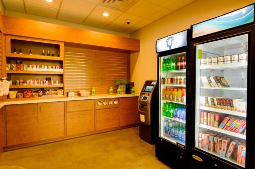 a grocery store with a drink cooler and a refrigerator at Pool - WiFi - Parking - Best Location ! in Kissimmee