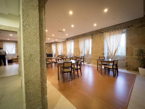 a dining room with wooden tables and chairs at Casa Das Morgadas in Nelas