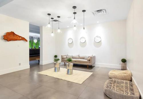 a living room with a couch and a table at Pool - WiFi - Parking - Best Location ! in Kissimmee