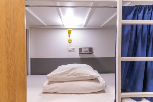 a bunk bed with a clock on the wall at ololoFreelander Hostel&Coworking in Bishkek