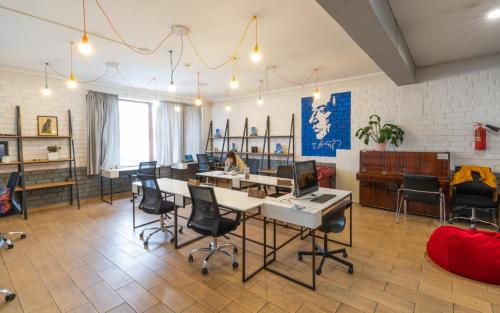 a room with chairs and a table and a couch at ololoFreelander Hostel&Coworking in Bishkek