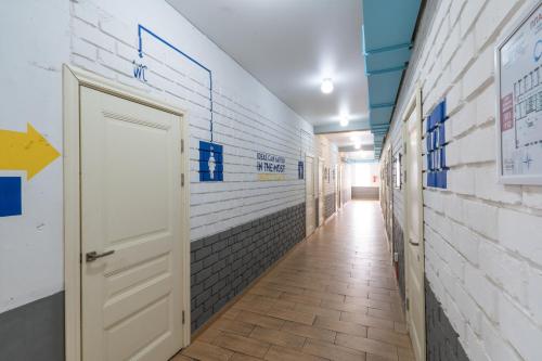 a hallway with blue and white tiled walls and a door at ololoFreelander Hostel&Coworking in Bishkek