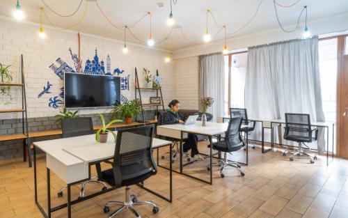 a man sitting at a table in an office at ololoFreelander Hostel&Coworking in Bishkek