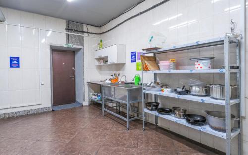 a kitchen with a bunch of pots and pans at ololoFreelander Hostel&Coworking in Bishkek