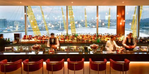 a bar with people standing at a bar at InterContinental London - The O2 in London