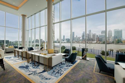 a large room with large windows and a view of the city at InterContinental London - The O2 in London