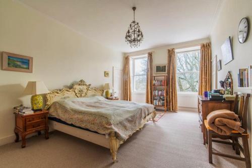 a bedroom with a bed and a table and a chair at Green Park in Bath