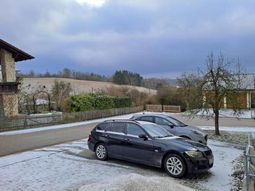 two cars parked next to each other in the snow at Plapperer`s Fewo in Schernfeld
