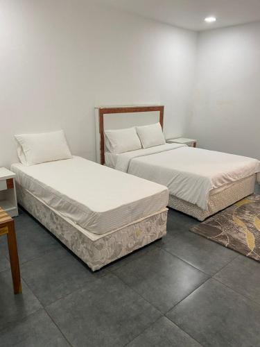 two beds sitting next to each other in a room at RESIDENCIAL AFRICA,LDA-NAMPULA in Nampula