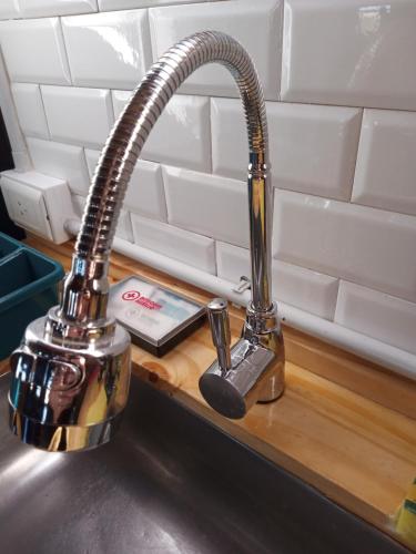 a kitchenaucet on a counter next to a sink at La Montañesa in Epuyén