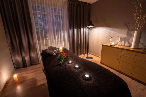 a bedroom with a bed with candles on it at Malina Apartamenty in Szklarska Poręba