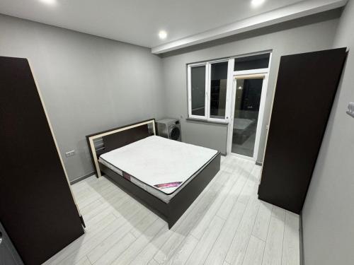 a bedroom with a bed and a window at RS apartment in Batumi