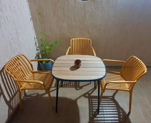 a table with two chairs and a bowl on top of it at An oasis close to the beach. in Martil