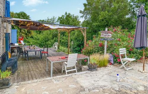 a patio with a table and chairs and an umbrella at Stunning Home In Fauroux With Wifi in Fauroux