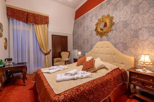 a bedroom with a bed with towels on it at Willa Barbara - ProHarmonia in Lądek-Zdrój