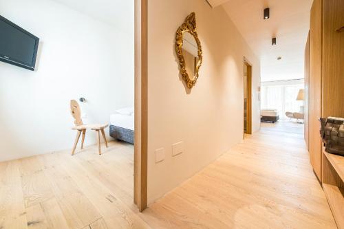 a hallway of a house with a mirror on the wall at Boutique-Hotel Ballguthof am Golfplatz in Lana