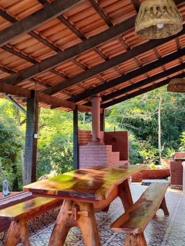 皮雷諾波利斯的住宿－Chácara Vale Dourado，木屋顶下的木餐桌