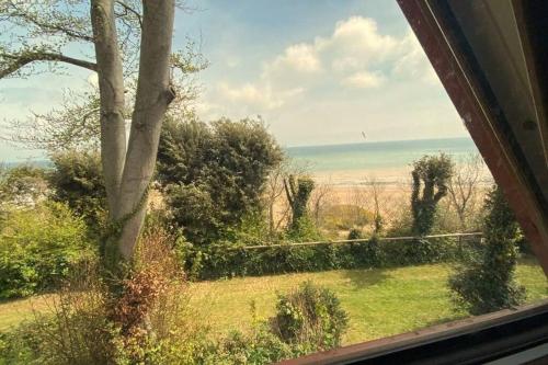 a view of a field from a window at FRONT LINE Chalet with OPEN Sea Views & Swimming Pool in Kingsdown No14 in Kingsdown