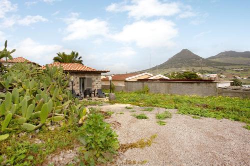 a small house with mountains in the background at Casa Do Vinho in Porto Santo