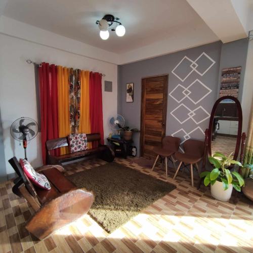 a living room with a bed and a table and chairs at Zia Homestay in Burgos