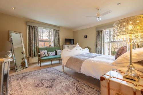 a bedroom with a large bed and a mirror at Ivy Farm 8 in Grimston