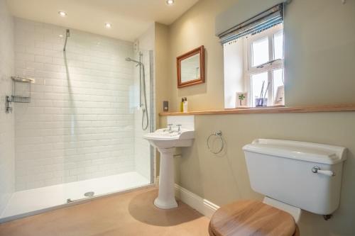 a bathroom with a shower and a toilet and a sink at Ivy Farm 8 in Grimston
