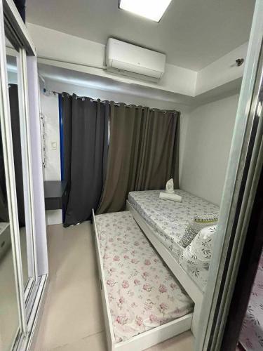 a small room with a bed and a window at Casa de Sea residence in Manila