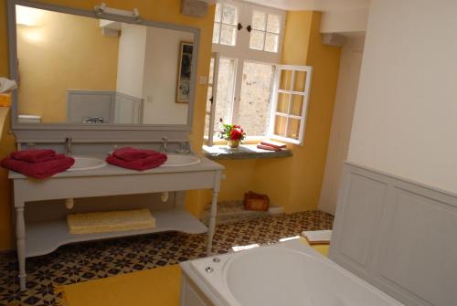 a bathroom with a sink and a mirror at Chateau de Flottemanville in Flottemanville