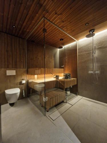 a bathroom with a toilet and a sink and a shower at Saariselkä Villas in Saariselka