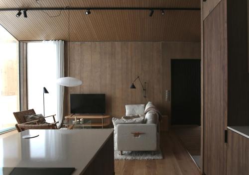a living room with a couch and a tv at Saariselkä Villas in Saariselka