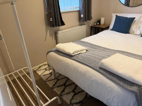 a bedroom with a bed with a blue pillow at The Great Haxby City Centre Free Parking Cardiff Bay in Cardiff