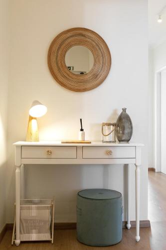 a white table with a mirror on the wall at Baleal Beachfront in Ferrel