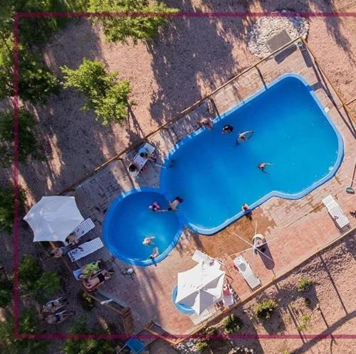 an overhead view of a large swimming pool with people around it at Posada San Vicente in San Rafael