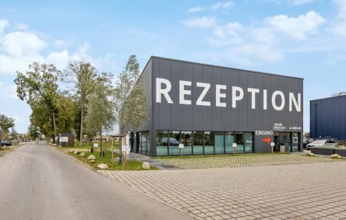 a building with a sign on the side of it at Nice Home In Lembruchdümmer See in Lembruch