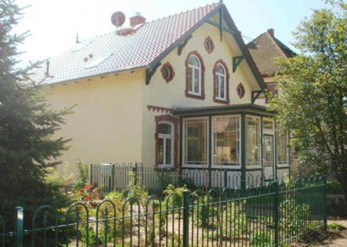 una casa con una valla delante de ella en Haus Paula - Am Rhododendronpark, en Graal
