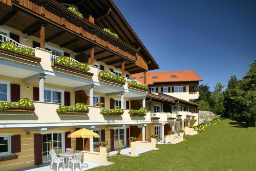 a large building with tables and chairs in a yard at Residenz Sonnenhang II in Füssen