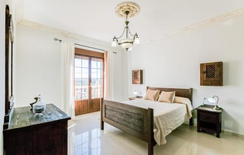 a white bedroom with a bed and a window at 3 Bedroom Awesome Home In Casariche in Casariche