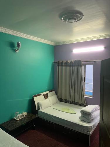 a small bed in a room with a window at Nagarkot Valley View Point Resort in Bhaktapur