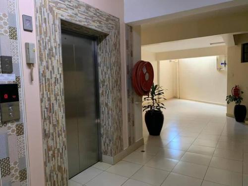 a hallway with a glass door with a plant in it at Spire Plaza 2 bedroom apartment in Nairobi