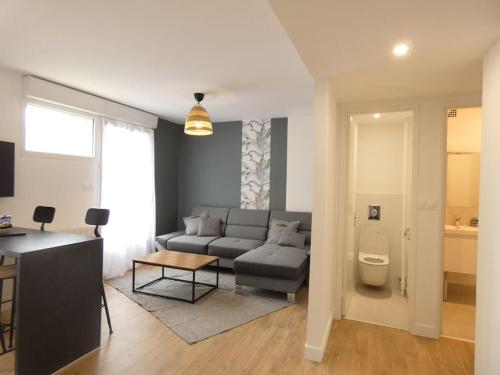 un salon avec un canapé et une table dans l'établissement Calme et Confort pour vos Séjours Moyenne Durée, à Brest