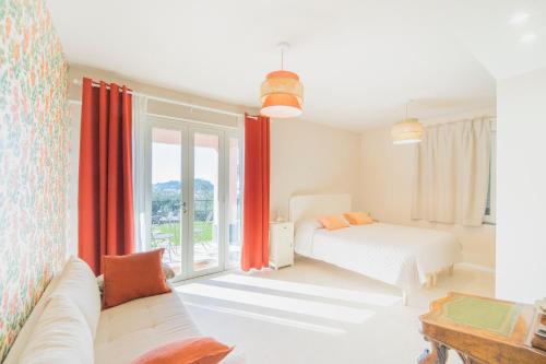 a white bedroom with a bed and a window at Villa Chicchi - Sestri Levante in Sestri Levante