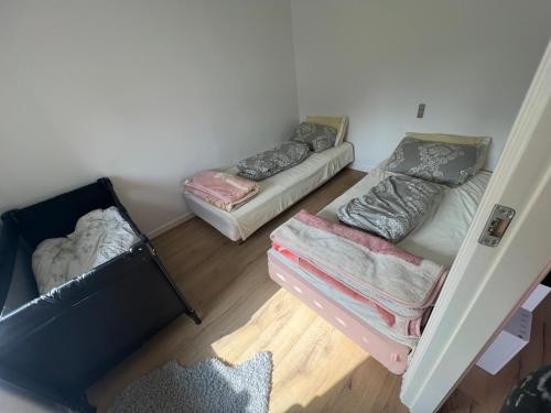 a small room with two beds and a couch at Nice small house 5 minutes to the sea in Ranum