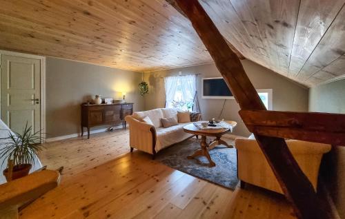 a living room with a couch and a table at Beautiful Home In Vedum With Kitchen in Vedum