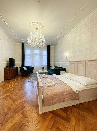 a bedroom with a large bed and a chandelier at Stupartska 9 - Premium Old Town Residence in Prague