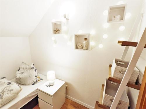 a small room with a bed and a staircase at Urlaubsmagie - Ferienwohnung Turmfalke - Garten mit Terrasse & Saisonaler Pool - H6 in Sebnitz