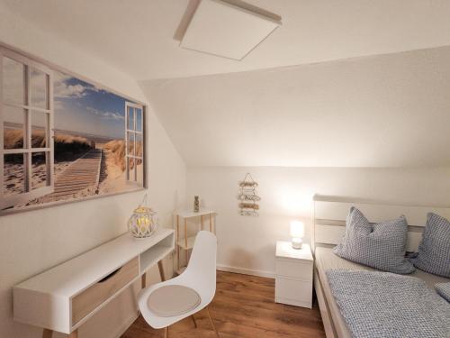 a bedroom with a bed and a desk and a bed and window at Urlaubsmagie - Ferienwohnung Turmfalke - Garten mit Terrasse & Saisonaler Pool - H6 in Sebnitz