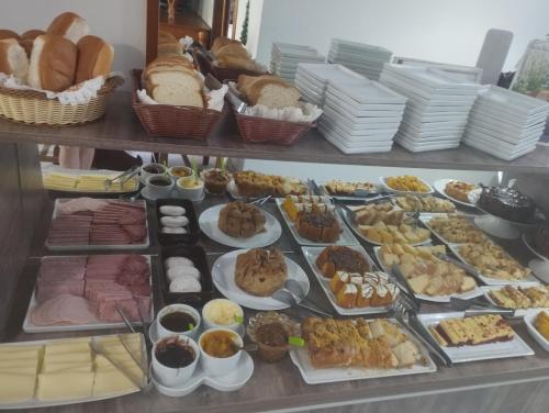 a buffet filled with lots of different types of food at Pousada Águia da Serra Gramado 1 in Gramado