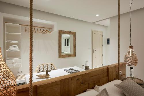 a bedroom with a hanging bed and a mirror at Nirome Luxury Suites in Adamas