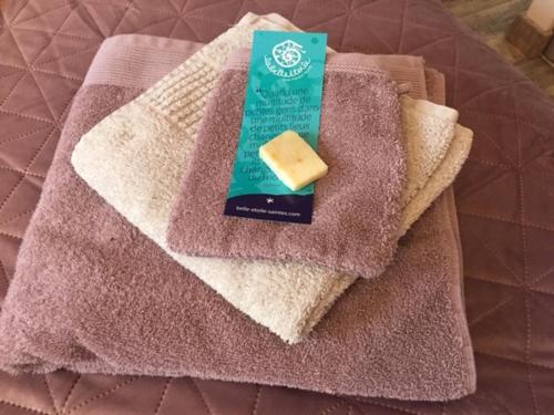 a block of cheese on a towel on a bed at La Belle Etoile in Saintes